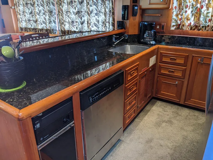 Pura Vida III Yacht Photos Pics 1999 Grand Alaskan Pilothouse kitchen with granite countertops and wooden cabinetry.