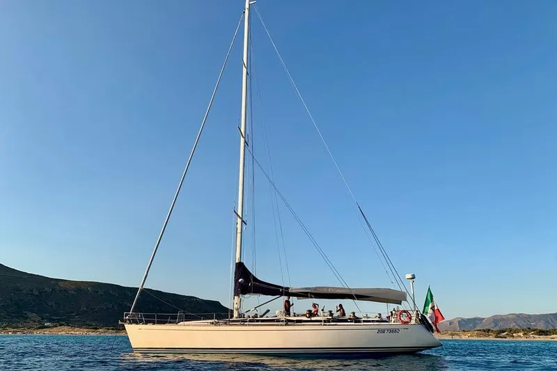 Vanish 2 Yacht Photos Pics Sailing yacht Nautor Swan 56, 1999 model, cruising on calm waters under clear blue skies.