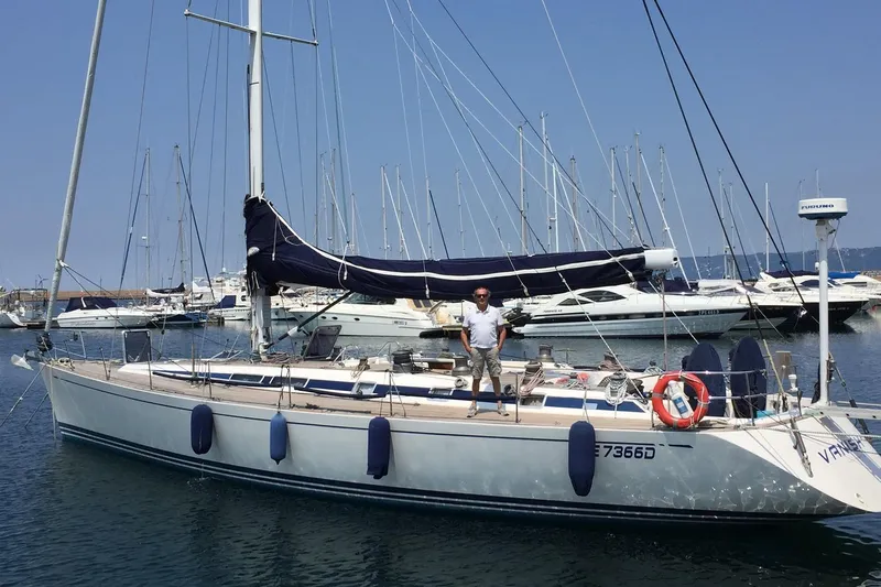 Vanish 2 Yacht Photos Pics Sailing yacht Nautor Swan 56, 1999 model, docked in marina with person on deck.