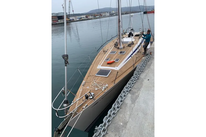 Vanish 2 Yacht Photos Pics 1999 Nautor Swan 56 yacht docked, featuring sleek wooden deck and modern design.