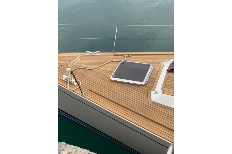 Vanish 2 Yacht Photos Pics Teak deck of 1999 Nautor Swan 56 yacht with hatch and railing.