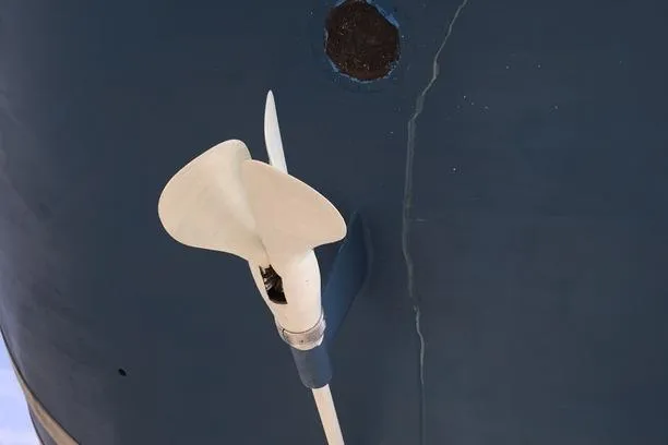 Vanish 2 Yacht Photos Pics Propeller of 1999 Nautor Swan 56 yacht against blue hull background.