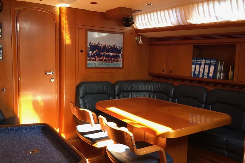 Vanish 2 Yacht Photos Pics Luxurious interior of 1999 Nautor Swan 56 yacht with wooden furnishings and seating area.