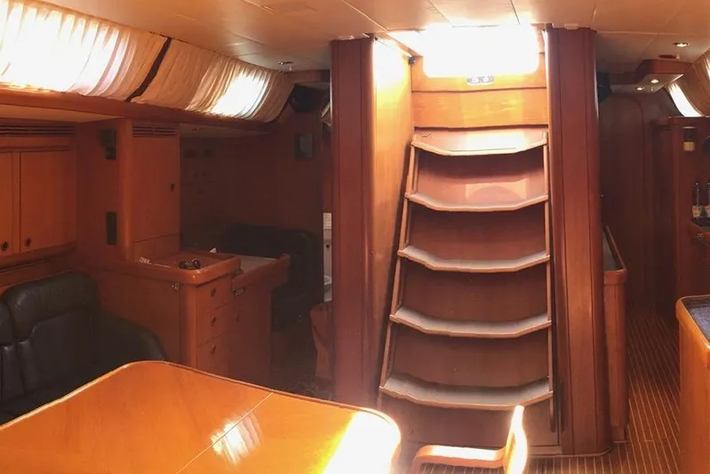 Vanish 2 Yacht Photos Pics Interior of 1999 Nautor Swan 56 yacht, featuring wooden furnishings and staircase.