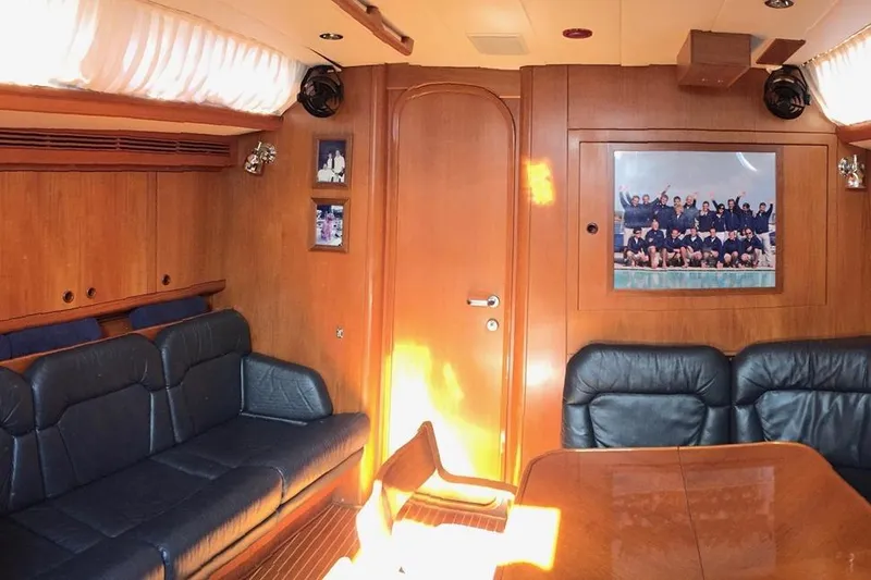 Vanish 2 Yacht Photos Pics Luxurious interior of 1999 Nautor Swan 56 yacht with leather seating and wooden finishes.