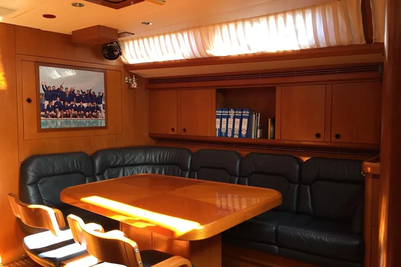 Vanish 2 Yacht Photos Pics Luxurious interior of 1999 Nautor Swan 56 yacht with wooden furnishings and leather seating.