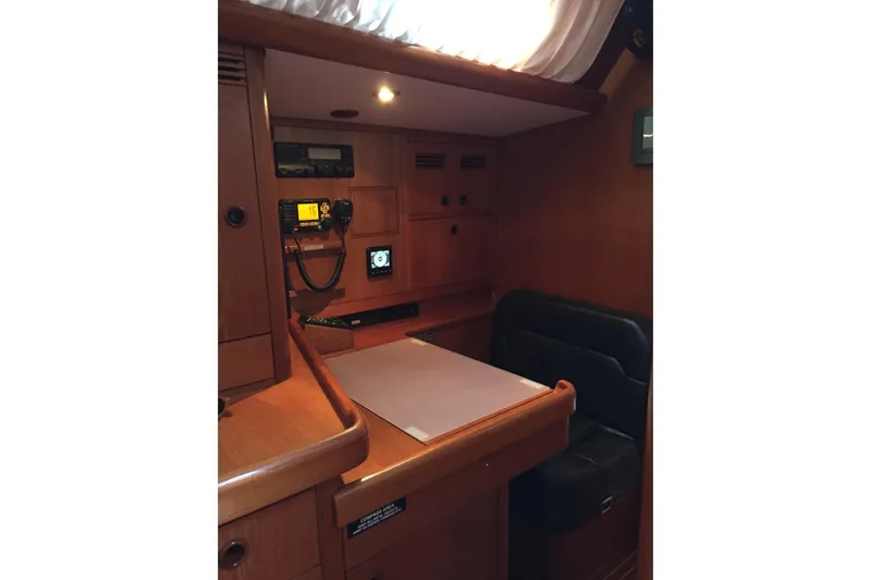 Vanish 2 Yacht Photos Pics Navigation station in 1999 Nautor Swan 56 yacht with wooden interior and communication equipment.