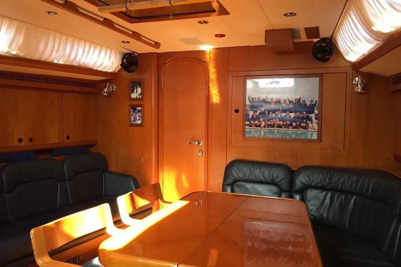 Vanish 2 Yacht Photos Pics Luxurious interior of 1999 Nautor Swan 56 yacht with elegant wood paneling and leather seating.