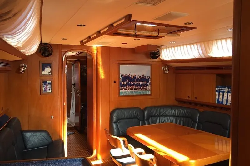 Vanish 2 Yacht Photos Pics Luxurious interior of 1999 Nautor Swan 56 yacht with elegant wood finish and seating area.