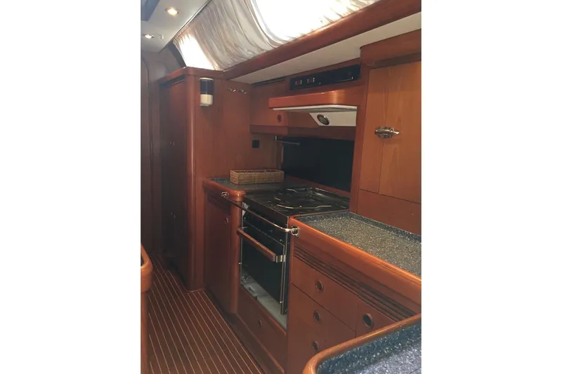 Vanish 2 Yacht Photos Pics Luxurious wooden galley interior of 1999 Nautor Swan 56 yacht with modern amenities.