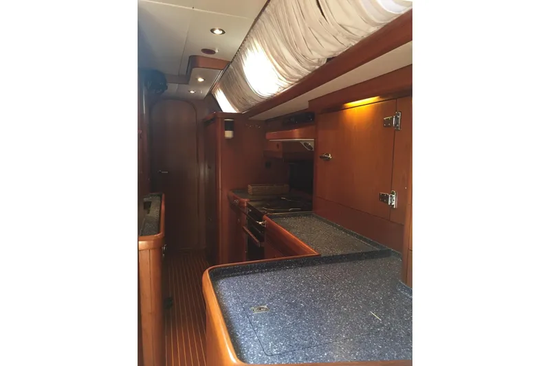 Vanish 2 Yacht Photos Pics Interior of 1999 Nautor Swan 56 yacht, featuring a sleek wooden galley design.