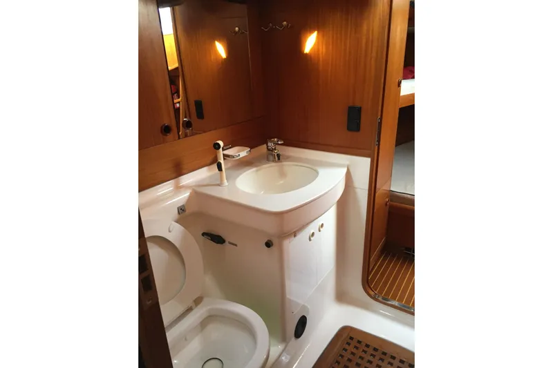 Vanish 2 Yacht Photos Pics Bathroom interior of 1999 Nautor Swan 56 yacht with wooden accents and modern fixtures.