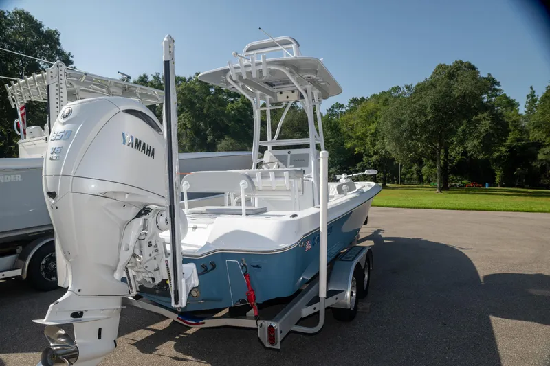  Yacht Photos Pics 2025 Contender 26 Bay boat with Yamaha engine on trailer, parked outdoors.
