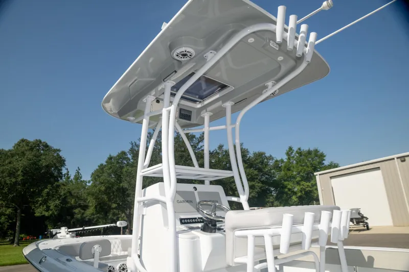  Yacht Photos Pics 2025 Contender 26 Bay boat with T-top and seating, outdoors under clear sky.