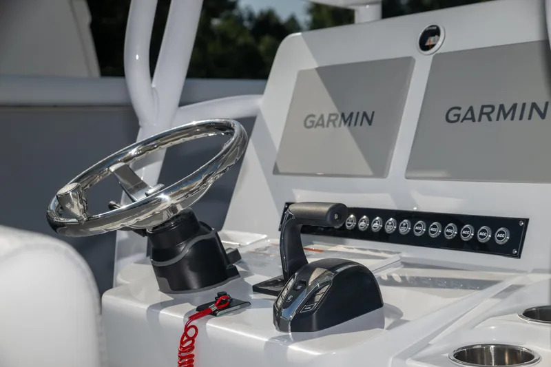  Yacht Photos Pics 2025 Contender 26 Bay boat dashboard with Garmin displays and steering wheel.