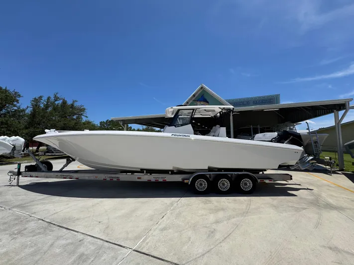  Yacht Photos Pics 2025 Fountain 38 TE boat on trailer under clear blue sky.