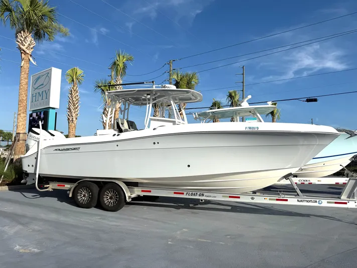  Yacht Photos Pics 2022 Aquasport 3000CC boat on trailer at HMY Yachts dealership.