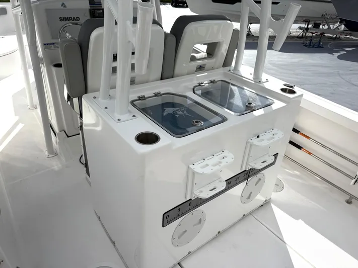  Yacht Photos Pics 2022 Aquasport 3000CC boat interior with fishing rod holders and storage compartments.