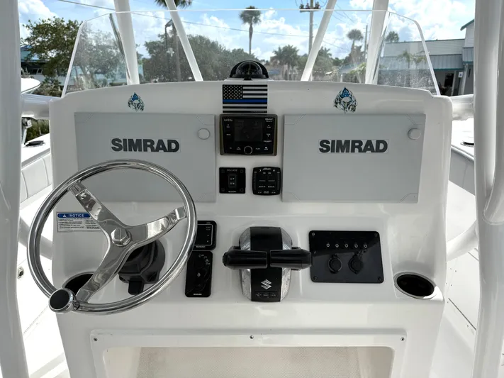  Yacht Photos Pics 2022 Aquasport 3000CC boat dashboard with Simrad electronics and steering wheel.