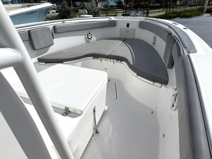  Yacht Photos Pics 2022 Aquasport 3000CC boat interior with cushioned seating and storage.