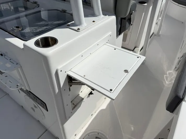  Yacht Photos Pics 2022 Aquasport 3000CC boat interior with fold-out table and cup holder.