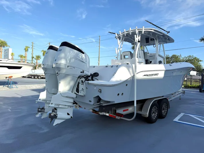  Yacht Photos Pics 2022 Aquasport 3000CC boat with dual Suzuki engines on a trailer.