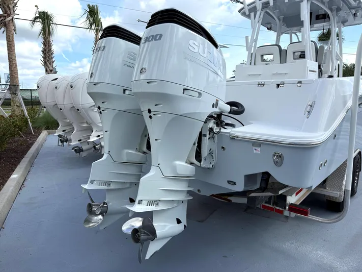  Yacht Photos Pics 2022 Aquasport 3000CC boat with dual Suzuki outboard motors, parked on a trailer.