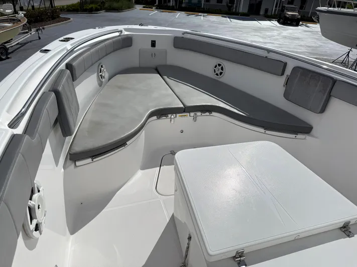 Yacht Photos Pics 2022 Aquasport 3000CC boat interior with cushioned seating and storage.