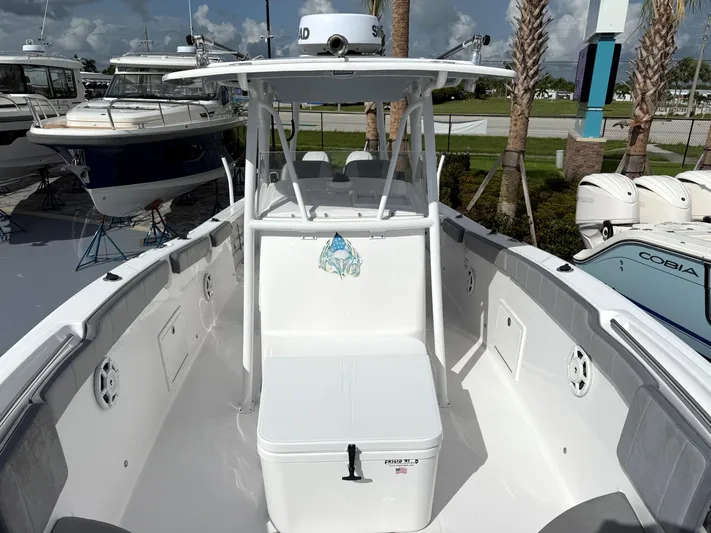  Yacht Photos Pics 2022 Aquasport 3000CC boat with center console and seating, docked near other boats.