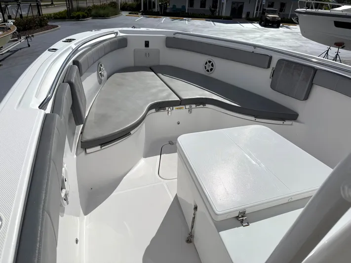  Yacht Photos Pics 2022 Aquasport 3000CC boat interior with cushioned seating and storage compartment.