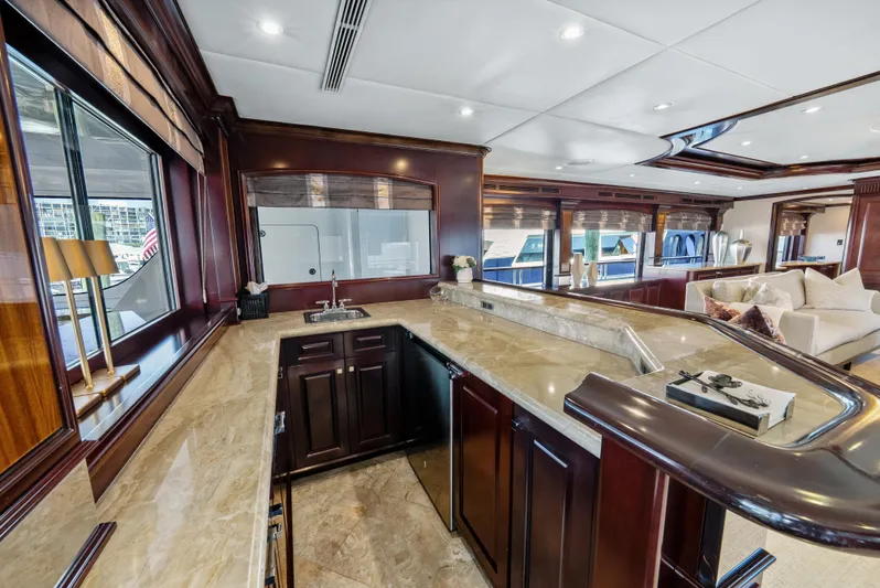 Nicole Evelyn Yacht Photos Pics Luxurious interior of 2005 Trinity Yachts Tri-Deck with elegant wood and marble finishes.