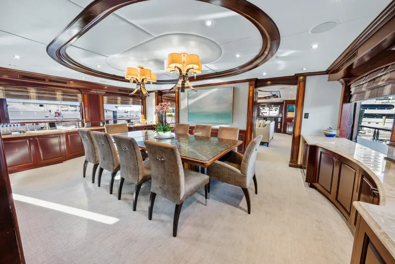 Nicole Evelyn Yacht Photos Pics Luxurious dining area on 2005 Trinity Yachts Tri-Deck, featuring elegant wood finishes and plush seating.
