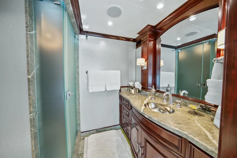 Nicole Evelyn Yacht Photos Pics Luxurious bathroom on 2005 Trinity Yachts Tri-Deck with elegant wood cabinetry and modern fixtures.