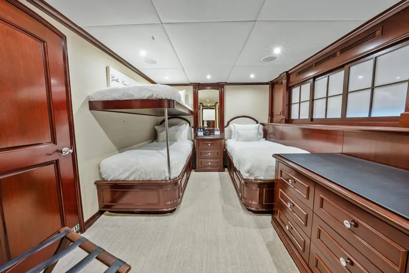 Nicole Evelyn Yacht Photos Pics Luxurious 2005 Trinity Yachts Tri-Deck cabin with elegant wood furnishings and twin beds.