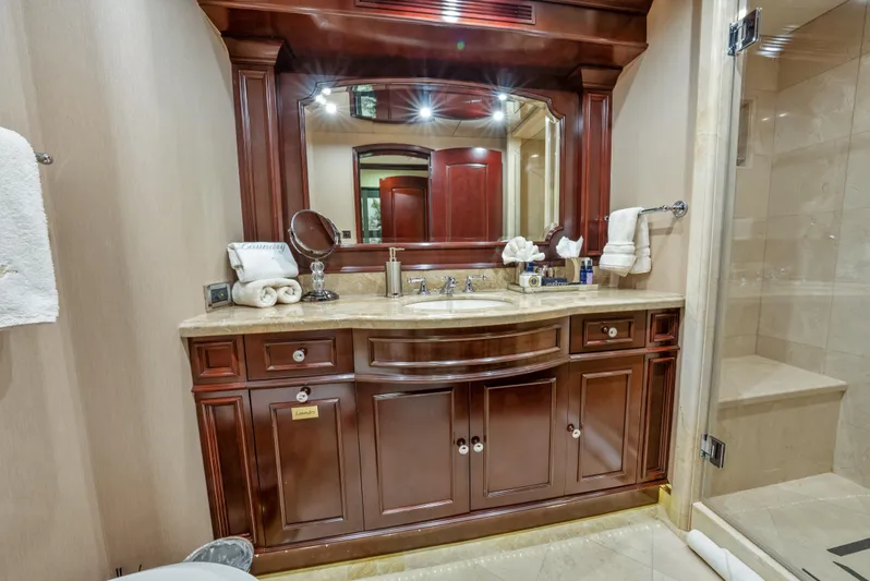 Nicole Evelyn Yacht Photos Pics Luxurious bathroom vanity on 2005 Trinity Yachts Tri-Deck, featuring elegant wood cabinetry and large mirror.