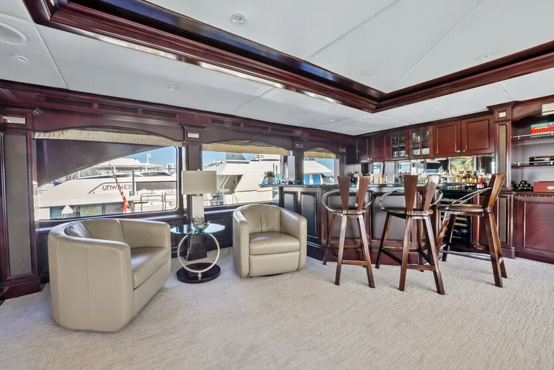 Nicole Evelyn Yacht Photos Pics Luxurious interior of 2005 Trinity Yachts Tri-Deck with elegant seating and bar area.