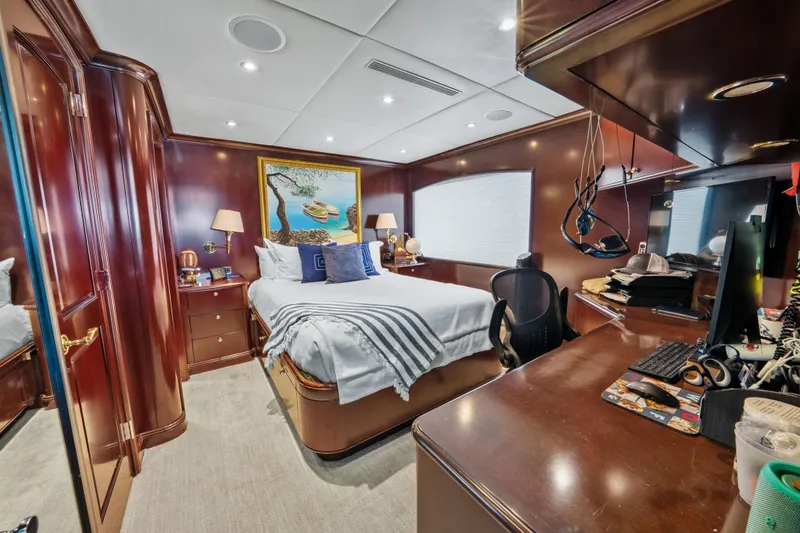 Nicole Evelyn Yacht Photos Pics Luxurious bedroom interior on 2005 Trinity Yachts Tri-Deck, featuring elegant wood finishes.