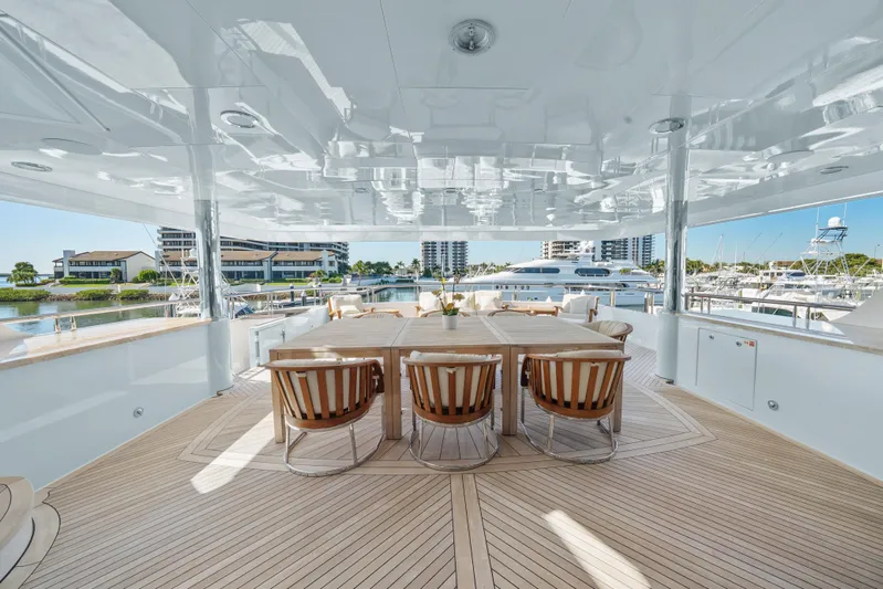 Nicole Evelyn Yacht Photos Pics Luxurious 2005 Trinity Yachts Tri-Deck with elegant outdoor dining area and marina view.