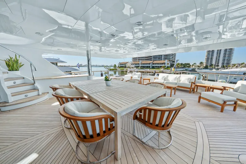 Nicole Evelyn Yacht Photos Pics Luxurious 2005 Trinity Yachts Tri-Deck with elegant outdoor seating and dining area.