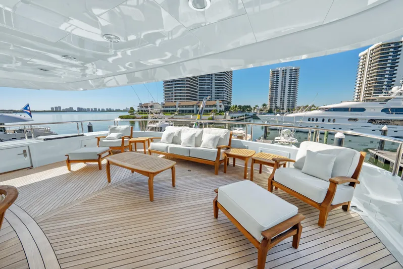 Nicole Evelyn Yacht Photos Pics Luxurious 2005 Trinity Yachts Tri-Deck with elegant outdoor seating and marina view.