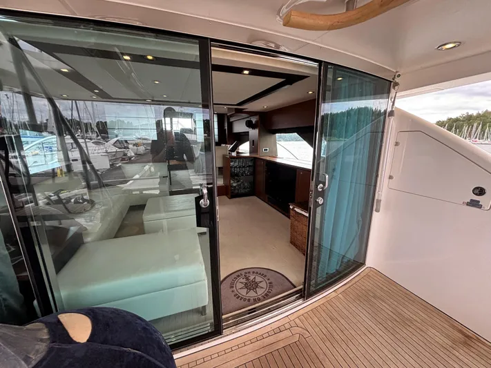 Schatzi Yacht Photos Pics Luxurious interior of 2013 Fairline Squadron 78 Custom yacht with sliding glass doors.