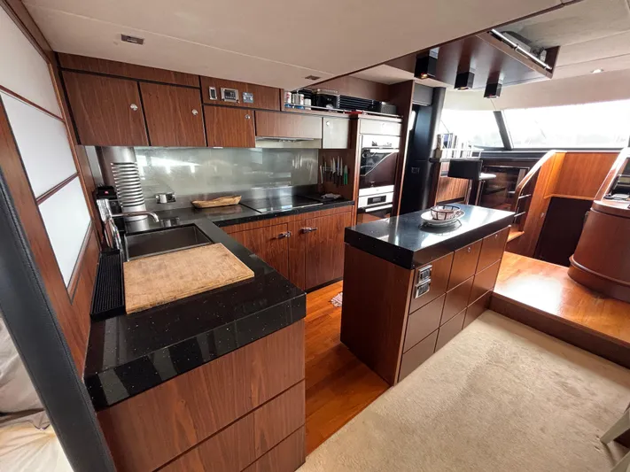 Schatzi Yacht Photos Pics Luxurious kitchen interior of 2013 Fairline Squadron 78 Custom yacht with modern wood cabinetry.