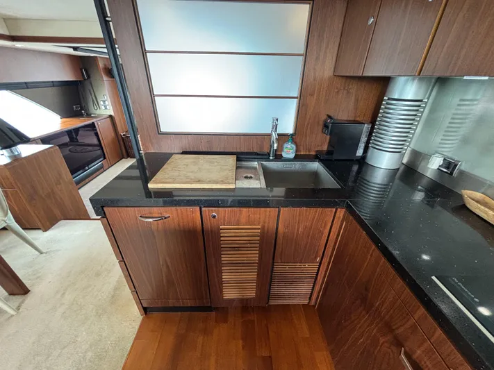 Schatzi Yacht Photos Pics Luxurious kitchen interior of 2013 Fairline Squadron 78 Custom yacht with wood cabinetry.