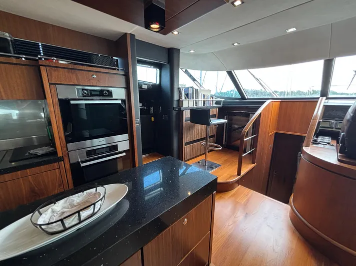 Schatzi Yacht Photos Pics Luxurious interior of 2013 Fairline Squadron 78 Custom yacht with modern kitchen and dining area.