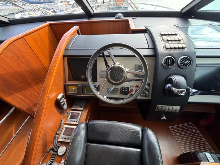 Schatzi Yacht Photos Pics Cockpit of 2013 Fairline Squadron 78 Custom yacht with steering wheel and controls.