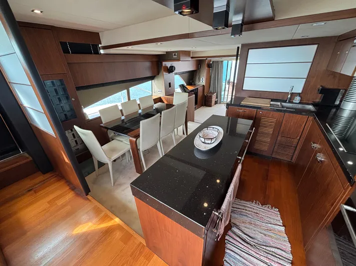 Schatzi Yacht Photos Pics Luxurious interior of 2013 Fairline Squadron 78 Custom yacht with elegant dining and kitchen area.