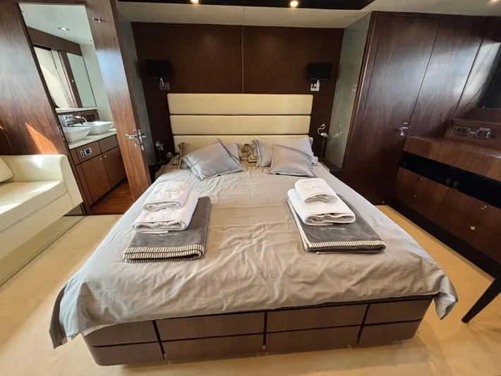 Schatzi Yacht Photos Pics Luxurious bedroom interior of 2013 Fairline Squadron 78 Custom yacht, featuring elegant wood finishes.