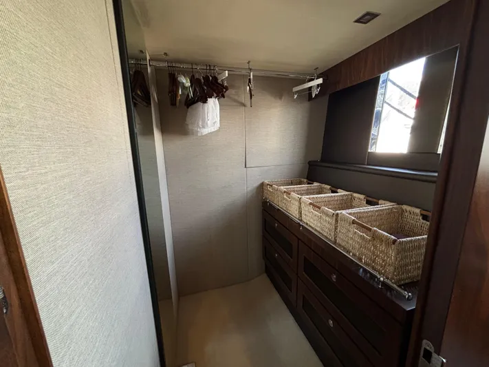 Schatzi Yacht Photos Pics Walk-in closet with wicker baskets and hangers on Fairline Squadron 78 Custom yacht, 2013 model.