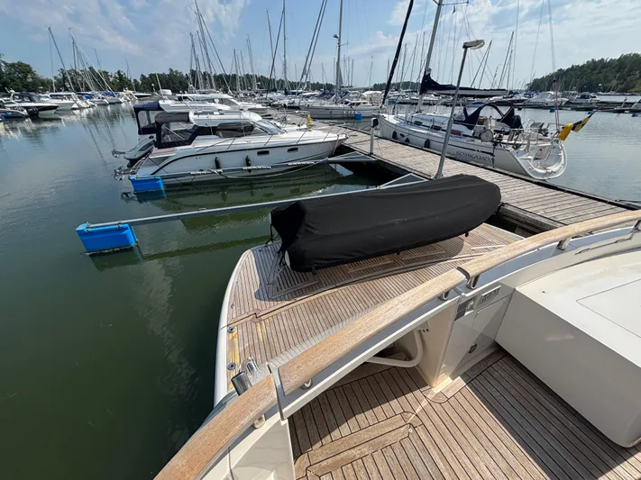 Schatzi Yacht Photos Pics 2013 Fairline Squadron 78 Custom yacht docked at marina with sailboats.