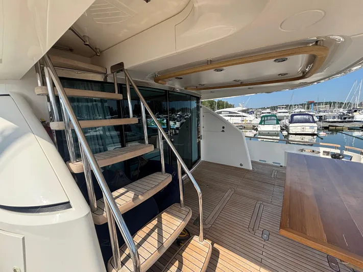 Schatzi Yacht Photos Pics Luxurious 2013 Fairline Squadron 78 Custom yacht with elegant wooden staircase and marina view.